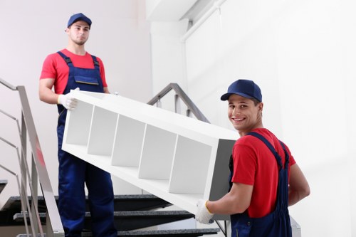 Furniture pick-up team preparing to remove a sofa in Brompton