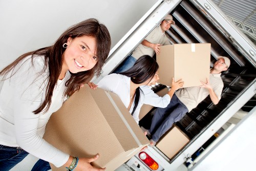 Packed office furniture and boxes ready for transport during a Brompton commercial move
